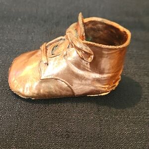 VINTAGE COPPER BRONZE D SHOE WITH TIED LASES.